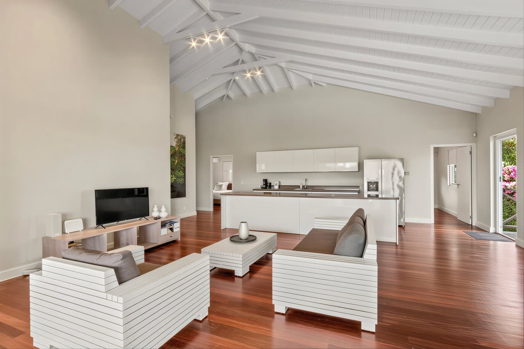 Living room with TV and seating, cathedral ceilings
